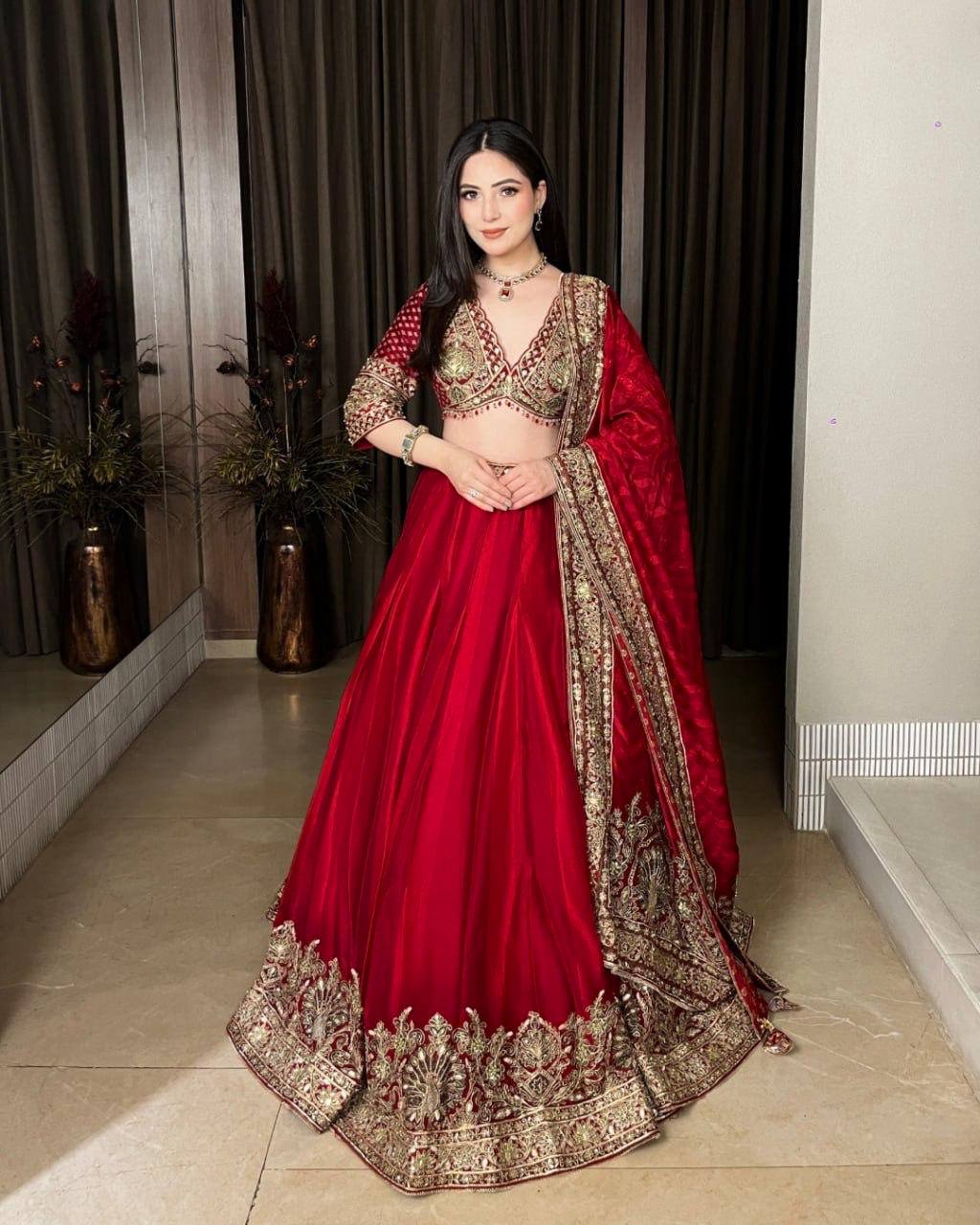Regal Crimson Red Bridal Lehenga Choli Ensemble Featuring Intricate Gold Zari Embroidery, Heritage Motifs, and Embellished Tassels